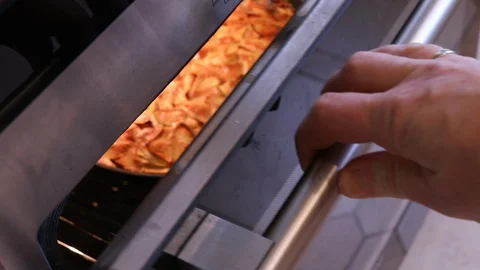Apple pie baking on oven Stock Footage 128804814