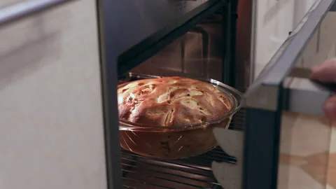 Apple pie baking on oven Video stock 166995582