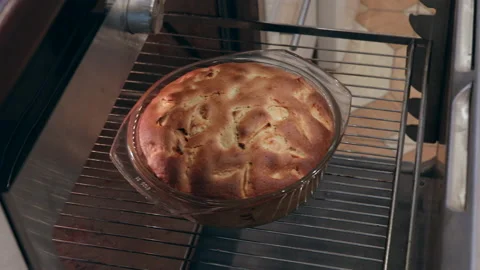 Apple pie baking on oven Stock Footage 166995811