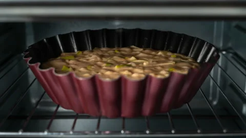 Apple Pie is baking in the oven, rising dough with fruit, close-up timelapse Stock Footage 165904117