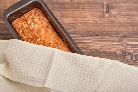 Apple pie in a baking tray on a brown wooden table. Apple charlotte. Homemade Stock Photos