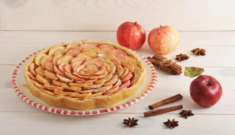 Apple pie with cinnamon on a plate and apples and cinnamon Stock Photos