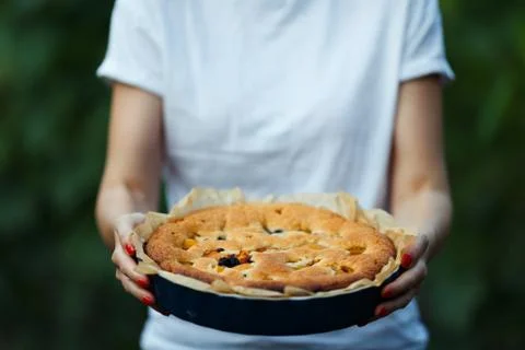 Apple pie in the hands of the cook Stock Photos