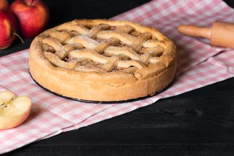 Apple pie on a kitchen table. Home baked pastry. Traditional dessert. Stock Photos