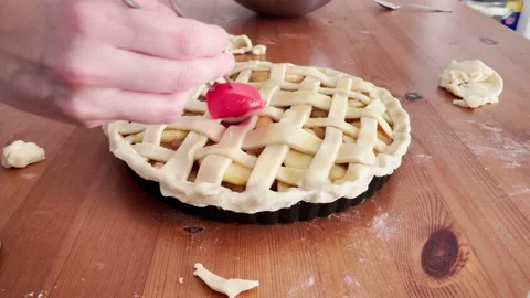 Apple pie making process. Painting the tart lattice with egg before baking. Stock Footage 218585794