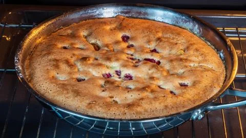 Apple pie in the oven Stock Photos