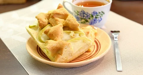 Apple pie piece and cup of tea. Fresh homemade fruit apple tart. Stock Footage 87515019