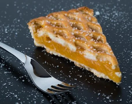 Apple pie slice on black table with fork Stock Photos
