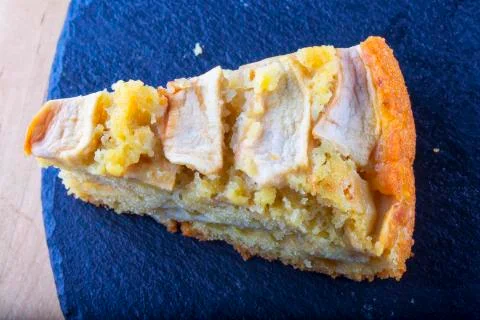 Apple pie slice over black stone Stock Photos
