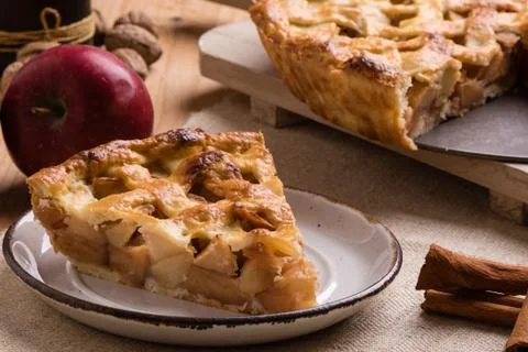 Apple pie slice on rustic setting Stock Photos