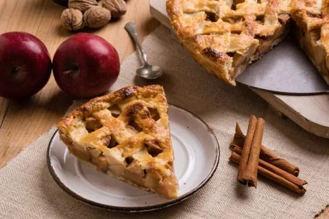 Apple pie slice on rustic setting Stock Photos