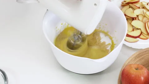 Apple pie step by step recipe. Whisk eggs with sugar in a bowl Stock Footage 144481108