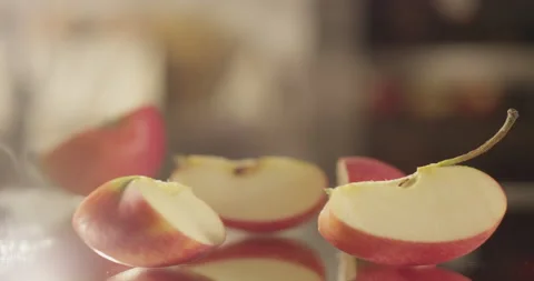 Apple pieces fall on a mirror surface Stock Footage 196942548