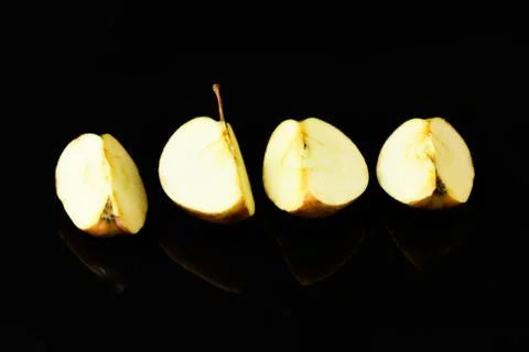 Apple pieces on isolated black background Stock Photos