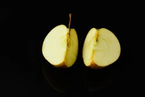 Apple pieces on isolated black background Stock Photos