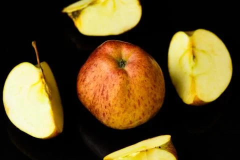 Apple pieces on isolated black background Stock Photos