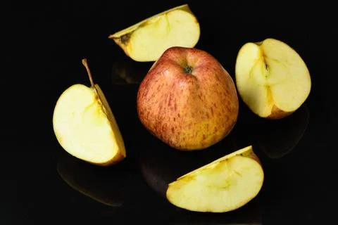 Apple pieces on isolated black background Stock Photos