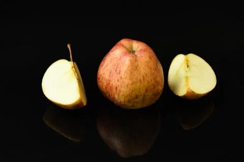 Apple pieces on isolated black background Stock Photos
