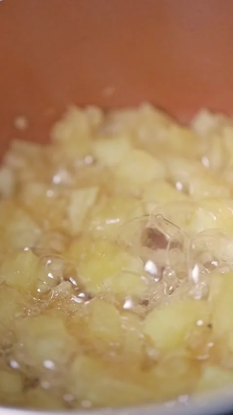 Apple pieces stew in a saucepan with boiling bubbles Stock Footage 290804599