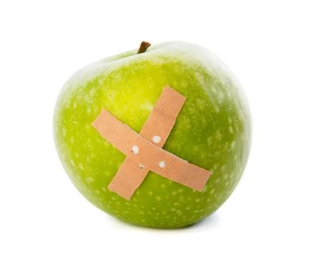 Apple with plaster against Stock Photos