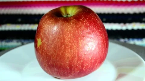 Apple on a plate Video stock 143153712