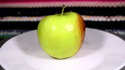 Apple on a plate Video stock 143153978