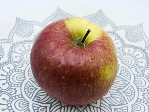 Apple on a plate, white background Stock-Fotos