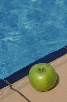 Apple at the pool side Stock Photos