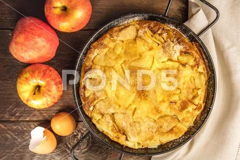 Apple puff pancake pie with apples and egg shells Stock Photos
