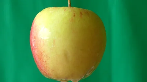 Apple rotates on a green background. 動画素材 113617219