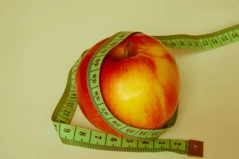 Apple with a ruler Stock Photos