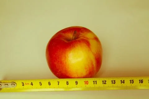 Apple with a ruler Stock Photos
