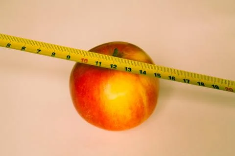 Apple with a ruler Stock Photos