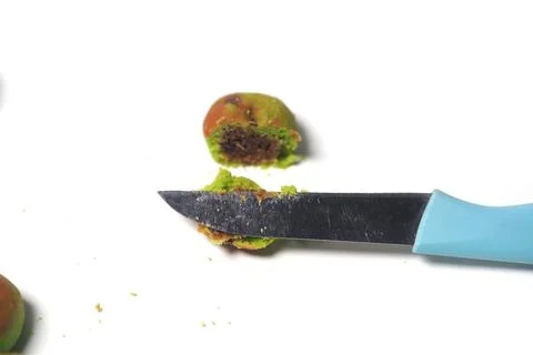 Apple-shaped cookie cut in half by a knife, showing the soft dough and dark.. Stock Photos