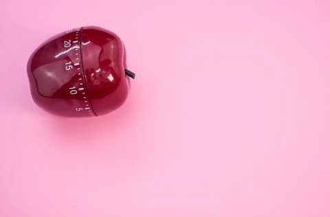 Apple-shaped kitchen timer isolated on pink background Stock Photos