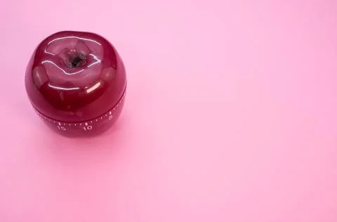 Apple-shaped kitchen timer isolated on pink background Stock Photos