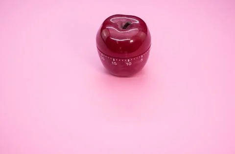 Apple-shaped kitchen timer isolated on pink background Stock Photos