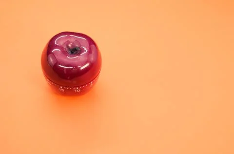 Apple-shaped kitchen timer isolated on orange background Stock Photos
