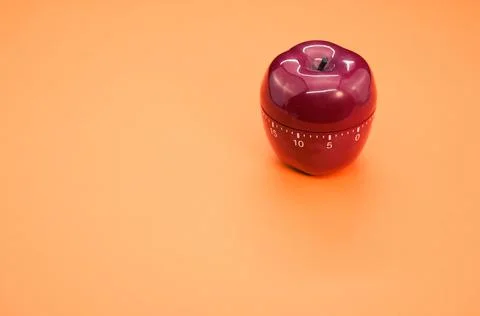 Apple-shaped kitchen timer isolated on orange background 스톡 사진