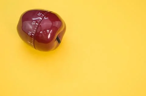 Apple-shaped kitchen timer isolated on yellow background 스톡 사진
