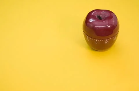 Apple-shaped kitchen timer isolated on yellow background 스톡 사진