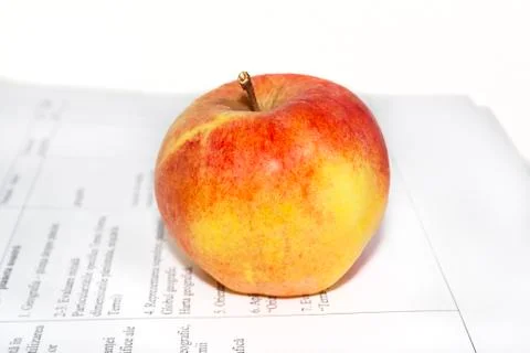 Apple on a sheet of paper Stock Photos