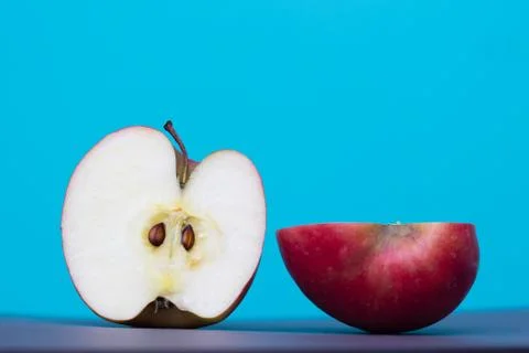 Apple sliced on blue background Stock Photos