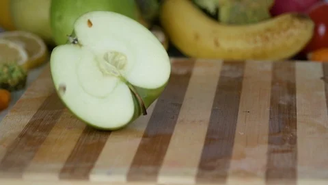 Apple slices are falling on cutting board in slow motion Stock Footage 98202780