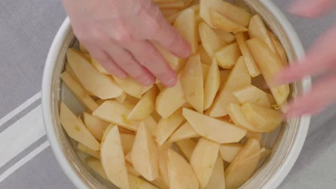 Apple slices in baking pan close-up on a kitchen table. Stock Footage 232539096