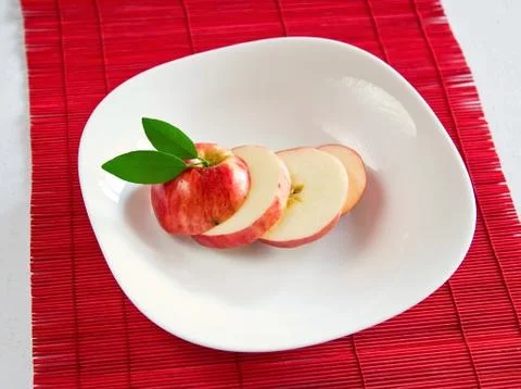 Apple slices on dish Stock Photos