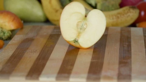 Apple slices fall on cutting board in slow motion Stock Footage 98201846