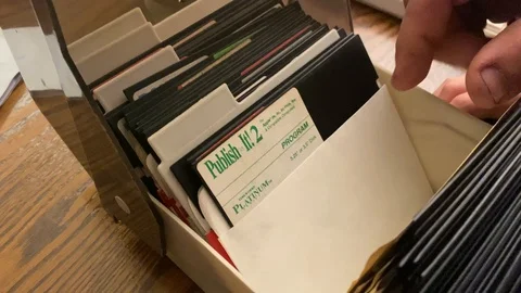 Apple software programs, games, diskettes in a storage box, five and a Stock Footage 124122065