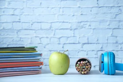 Apple ,stack of books and pencil on table Stock Photos