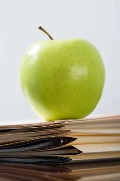 Apple on a stack of files Stock Photos